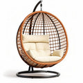 Hanging rattan patio chair with cream cushions and 70 x 70 x 120cm dimensions