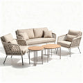 Outdoor rattan sofa set with beige cushions and wood accent table